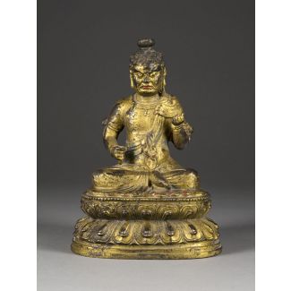 Eine vergoldete sitzende bronzefigur von acala