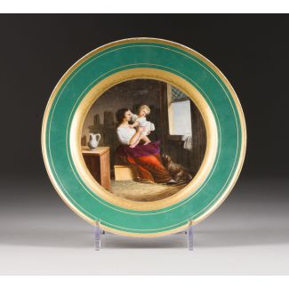 A PORCELAIN PLATE WITH AN IMAGE OF A MOTHER WITH A CHILD 