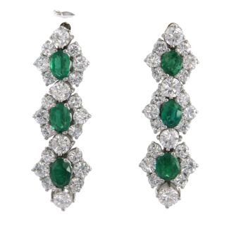 White gold earrings set with emerald