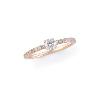 Rose gold solitaire ring with central diamond and diamond-set band